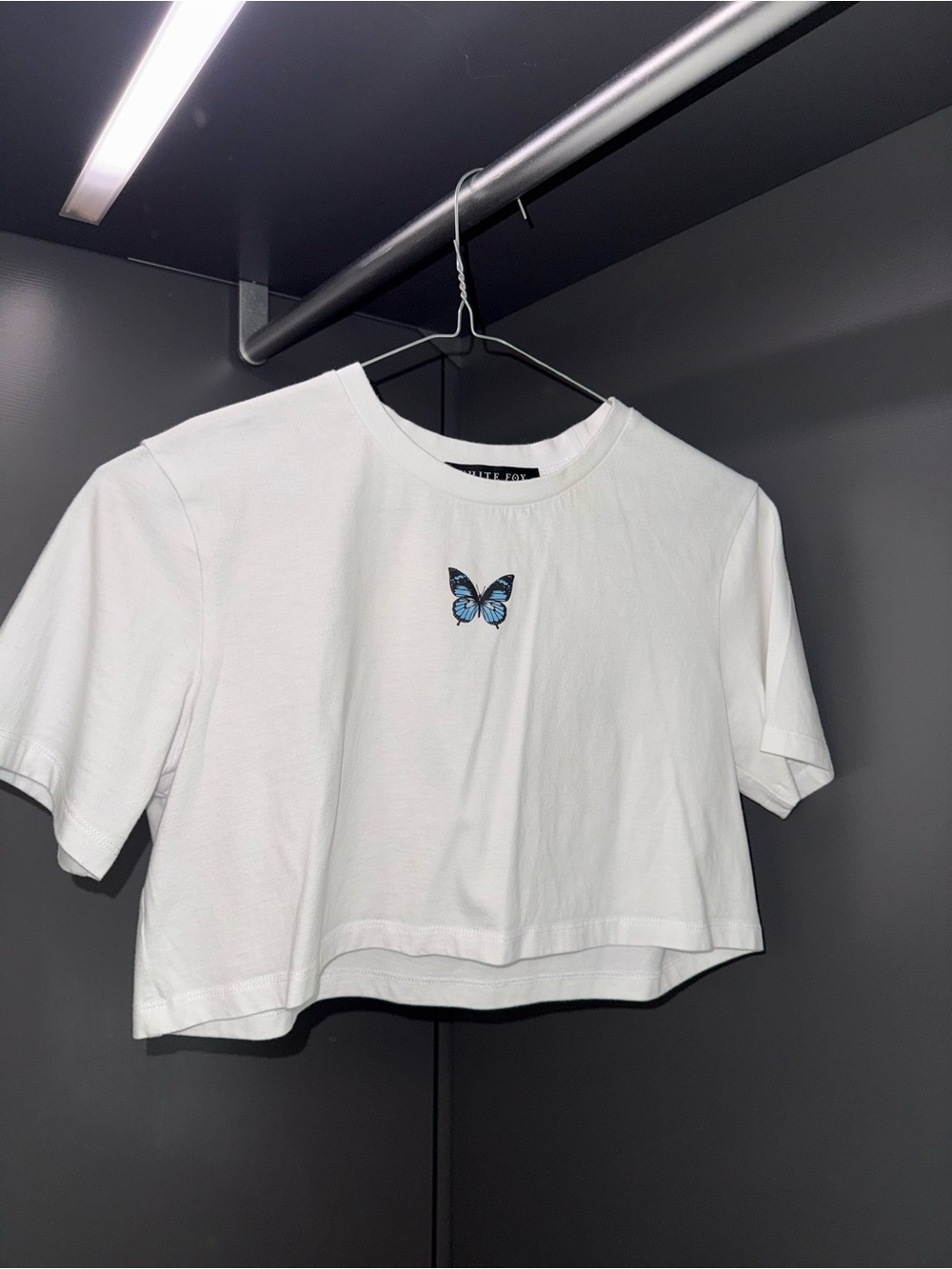 White Fox Boutique White Cropped Tee with Blue Butterfly Patch
